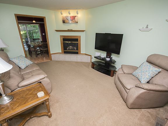 Walking through the front door in the tile entry, you're immediately greeted with a large, warm living room (16x12) that features a gas fireplace, mantle, and track lighting.