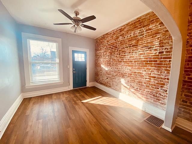 Open Concept Living Room w/ original exposed brick accent wall