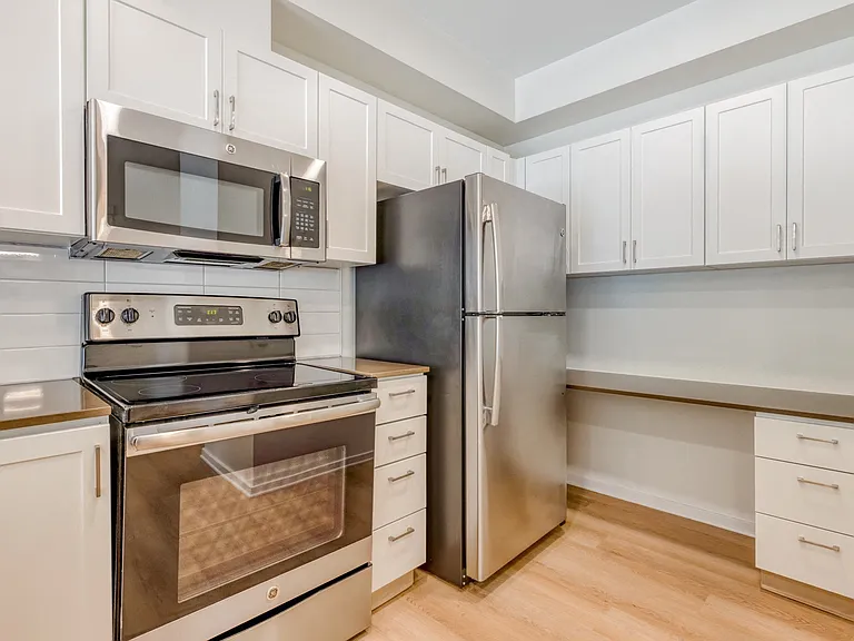Gourmet kitchens with stainless steel appliances and quartz counters