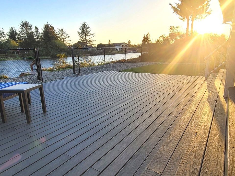 Some other wonderful amenities to this property are a completely finished garage, a new Trex dock that was installed in 2022, a new chainlink fence in 2022 encompassing the property with gates in the front, the rear, and both sides; an Interloc system was installed on the main breaker panel for a generator with inlet receptace in 2022; propane lines were plumbed to a fire table and a BBQ grill, that is hooked up to a leased propane tank; and finally there is a rear hose bib that has both separate hot and cold lines.>