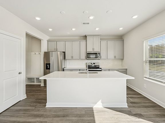 Create a sleek dining space with the modern, oversized kitchen island.