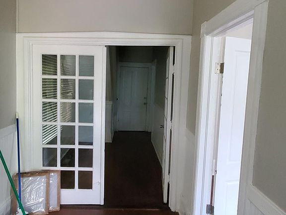 Foyer looking down small hall leading to kitchen.