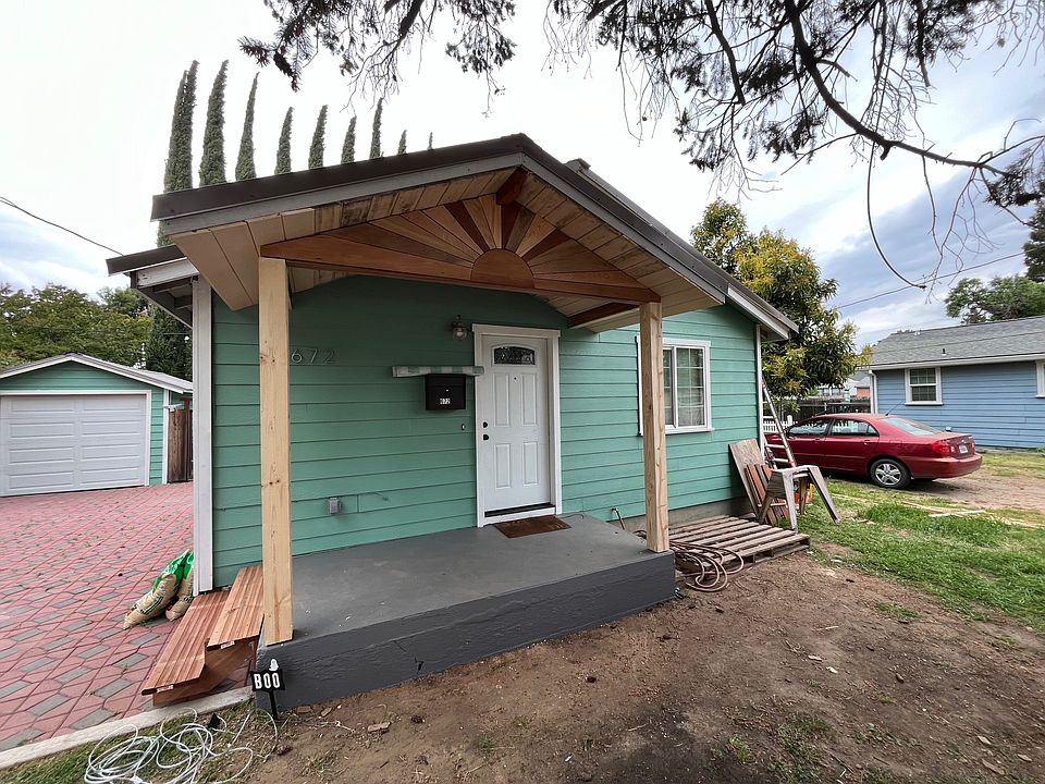 Hand crafted 'sunrise' front porch made with 5 types of hardwood.