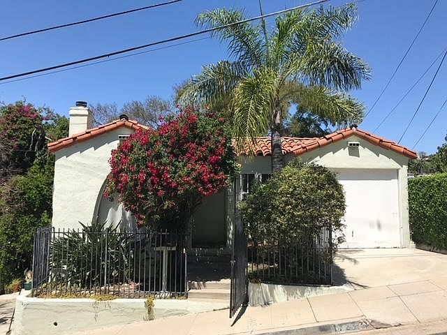 Spanish Style Architecture 1930's
Large Bougainvillea, yellow roses and palm tree in front of house.