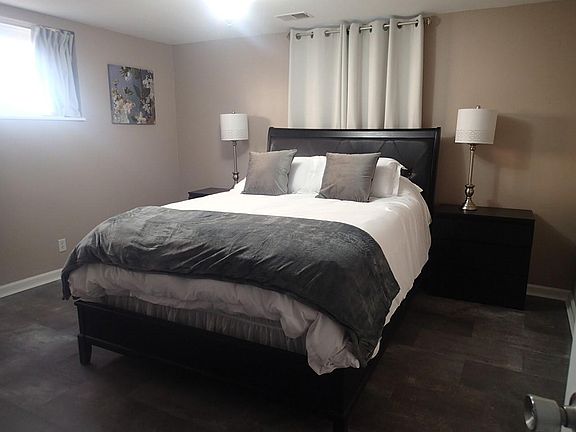 Bedroom with brand new Queen mattress, luxurious linens