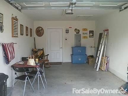 Garage : Ceiling has drop down aluminum ladder to above garage storage area (lighted)