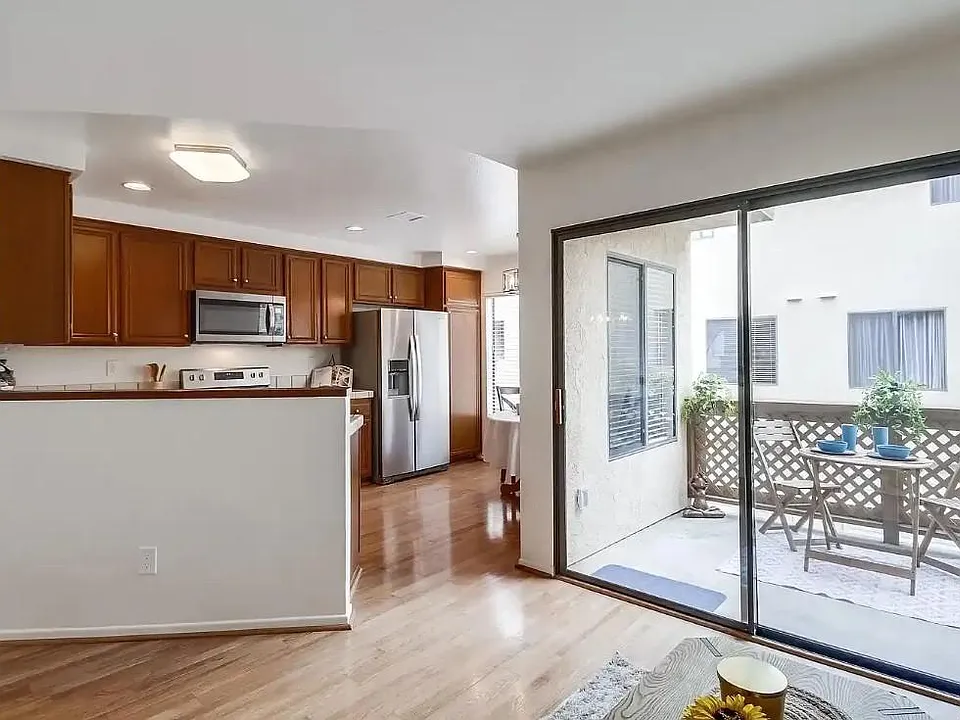 Looking into kitchen from family room. Balcony outside sliding glass doors
