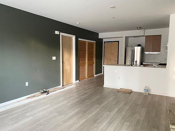 Large open area - again, sorry for the mess. We're installing the flooring right now and as you can see, it's almost done