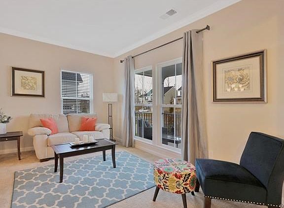 Living Room with crown molding; low windows provide a lot of natural lighting