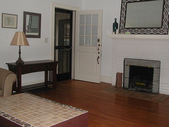 Entry into living room showing decorative fireplace.