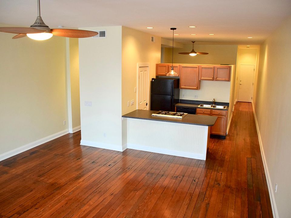 Main living area, kitchen and main hall with original, gleaming hardwood floors