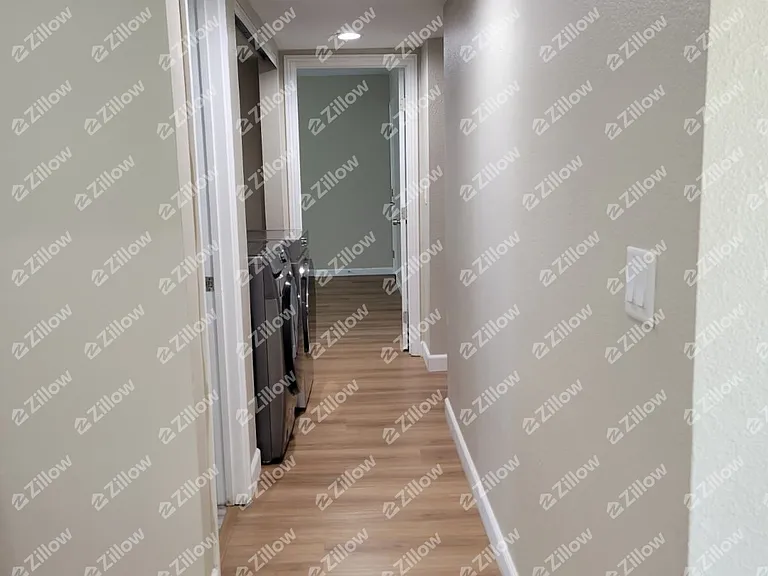 Hallway leading to laundry and bedrooms