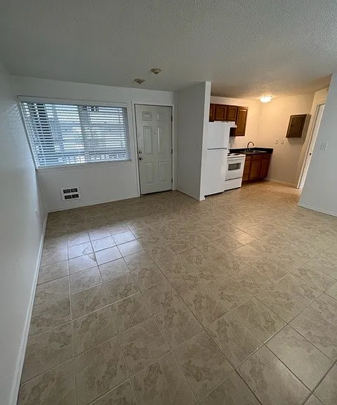 Apt #24, Tile Floors, Brown Cabinetry