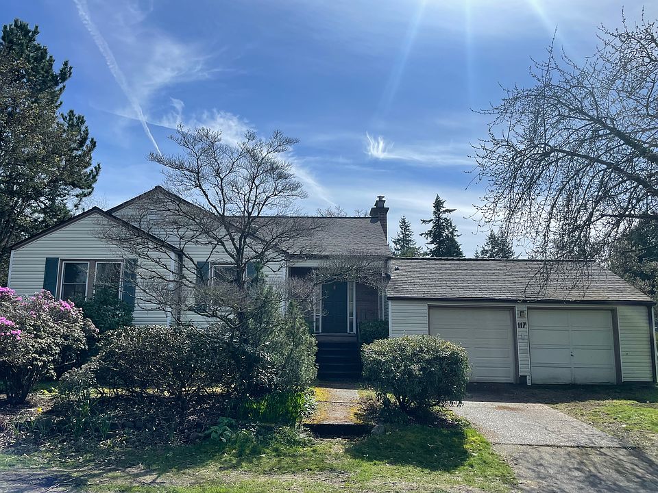 Front house view with mature landscaping about to bloom for Spring