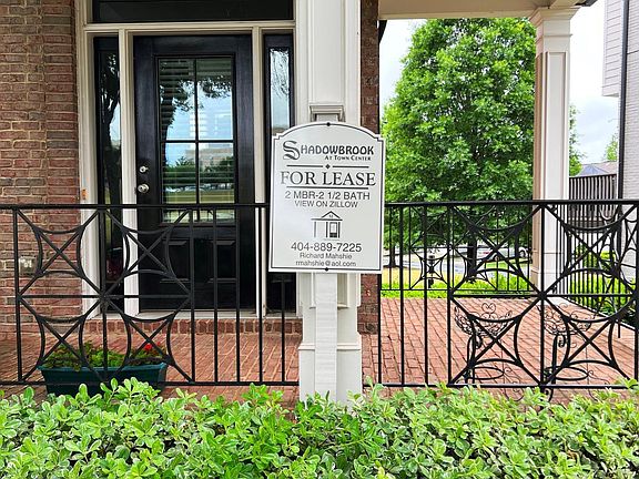 Private Front Porch view opens to large green area.