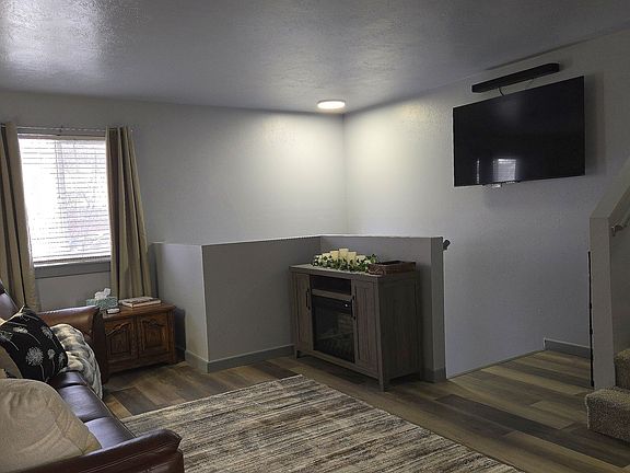 Living room with comfortable powered reclining furniture, fireplace and large TV w/sound bar. Netflix, Hulu, Amazon prime and fast internet for your convenience.