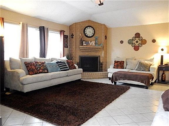 Well Lit and Spacious Living Room with a Fireplace.
