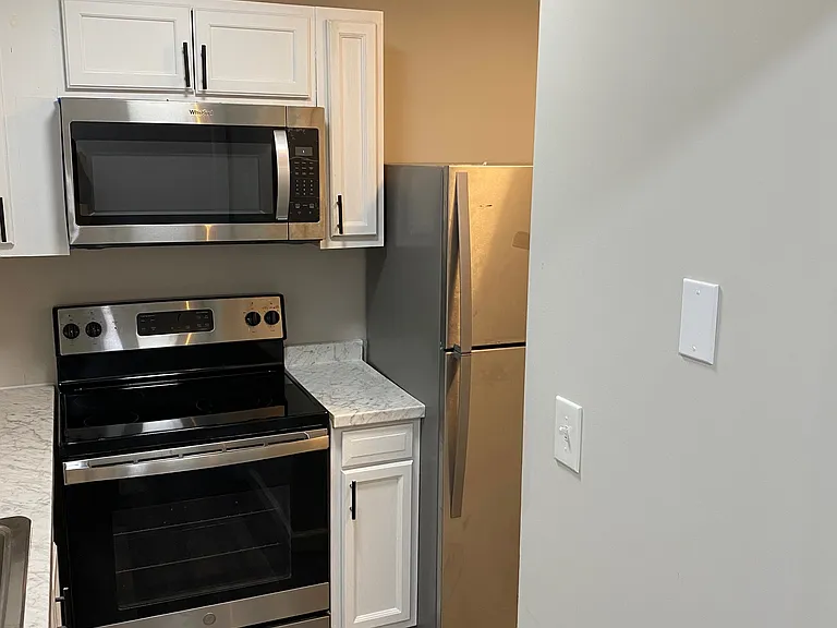 Right side of kitchen, with side by side laundry around the corner