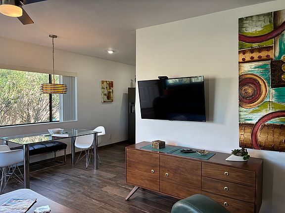 Flatscreen TV and kitchen around the corner.