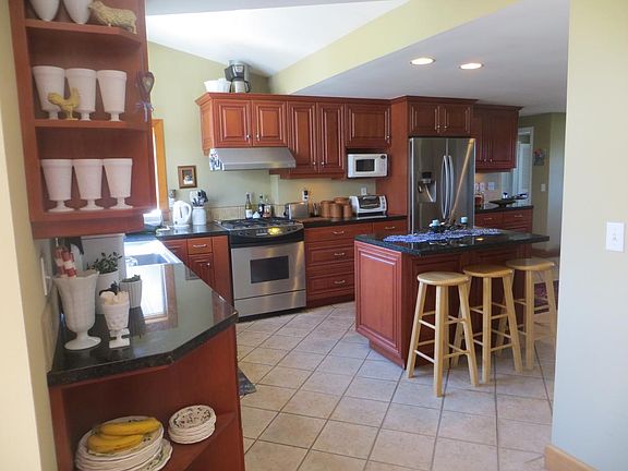 View from dining room into kitchen with island, gas range, s