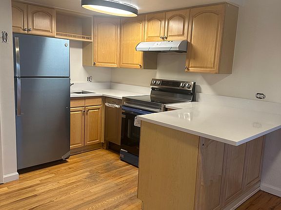 New stainless appliances and quartz top with eat-at bar.