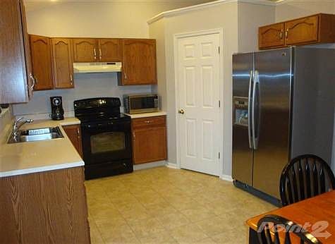 Another view of the kitchen shows of the brand new flooring and the walk-in pantry!