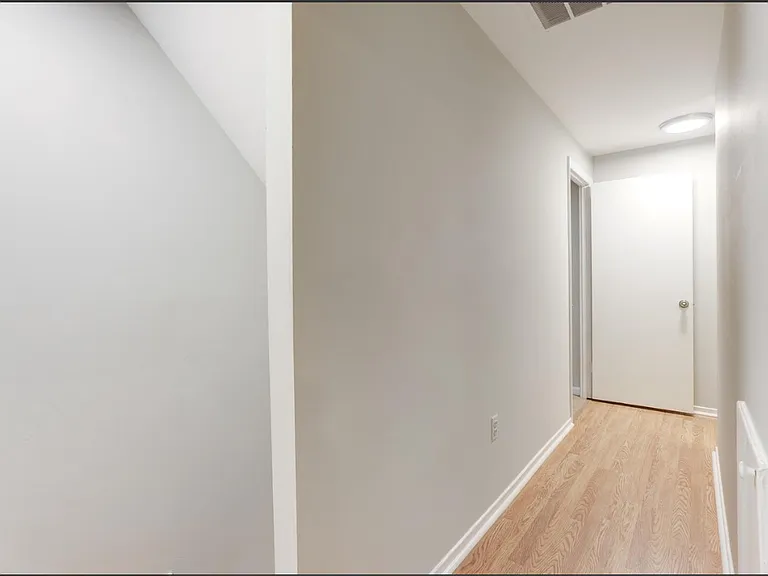 The second-floor foyer serves as a central landing space, providing easy access to all three bedrooms, two full bathrooms, and the conveniently located laundry area. Thoughtfully designed for comfort and functionality.