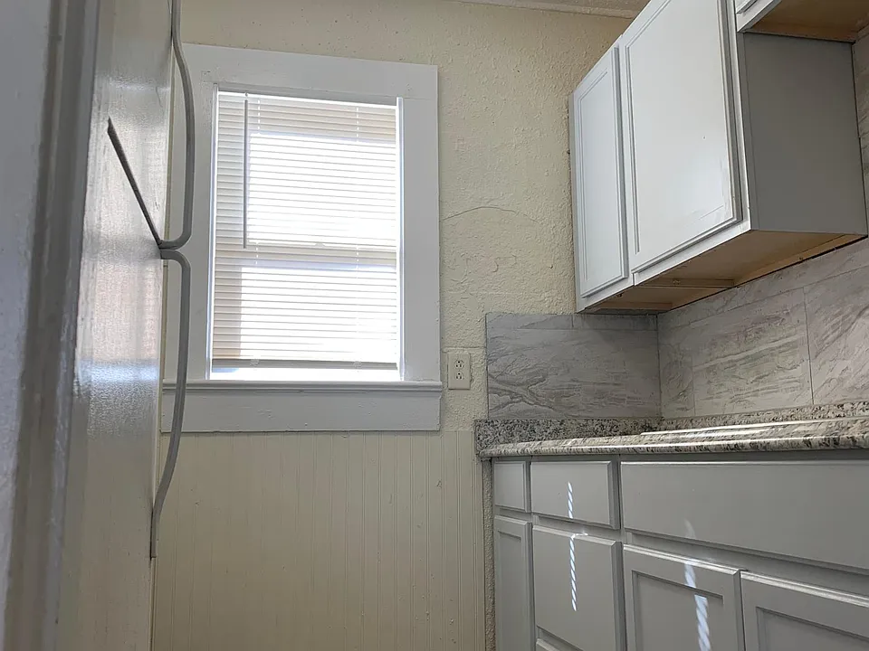 Kitchen with full size refrigerator next to stove