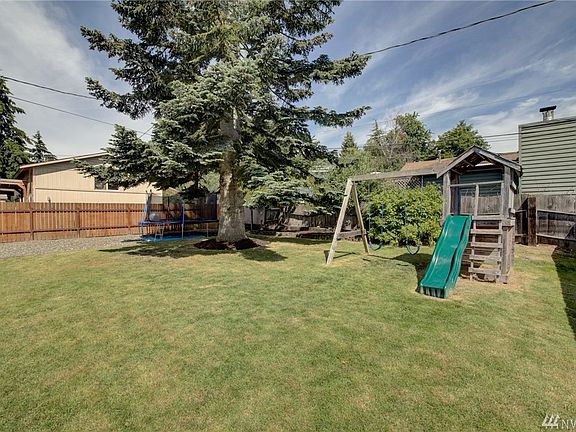 Lots of room for play structures or patios, in this case a trampoline. a great place for little ones to burn off some energy