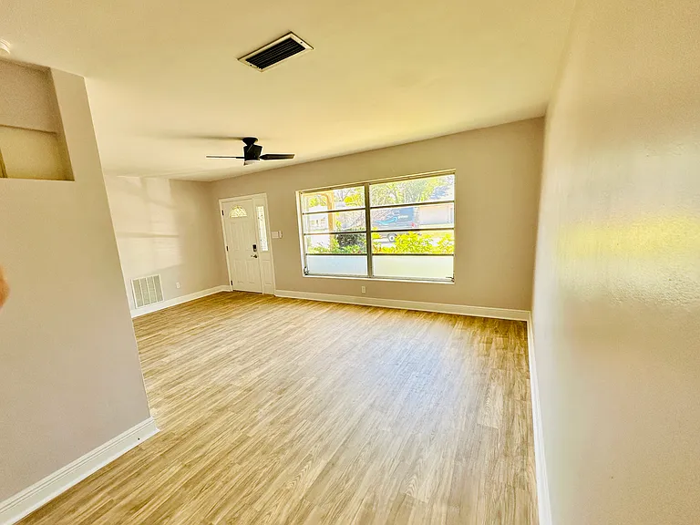 Good size family room with large window and curtains