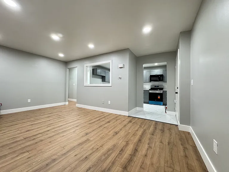 The living room includes brand new flooring and new ceiling lights.