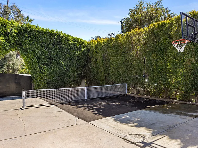 Step into a versatile play zone equipped with an extended tennis court and a basketball net.