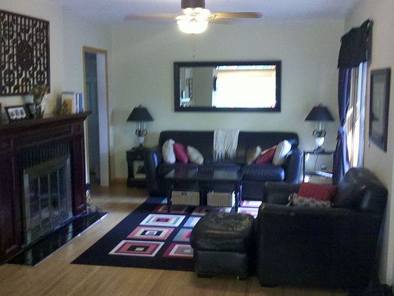 Upstairs Family Room with Hardwood Floors, Fireplace and Patio Door to Deck