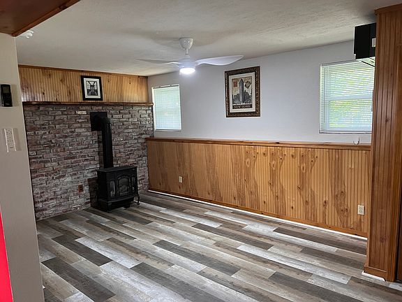 Living Room With Propane Stove & Ceiling Fan