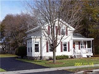Front of home with new drive and large yard.