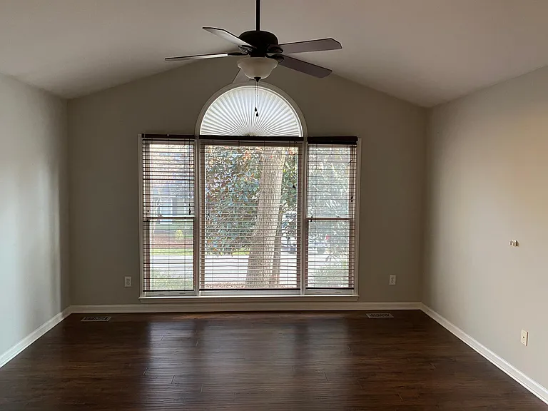 Main bedroom with large windows (lots of natural light) and vaulted ceilings.