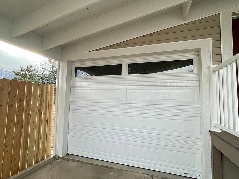 Garage with parking in front. There's also 6-car parking behind the house near rear entrance.