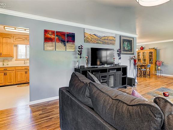 Entering the front door you look into the living room, kitchen, and dining room