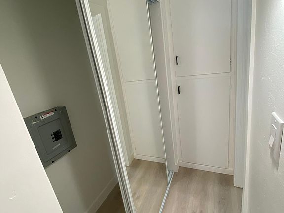 Hall Closets; Linen Straight Ahead and Left Hanging With Two Mirrored Doors Sliders