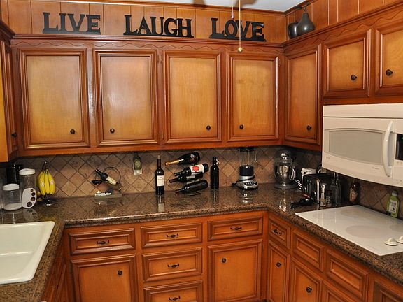 Updated kitchen with granite tile countertops and new appliances.