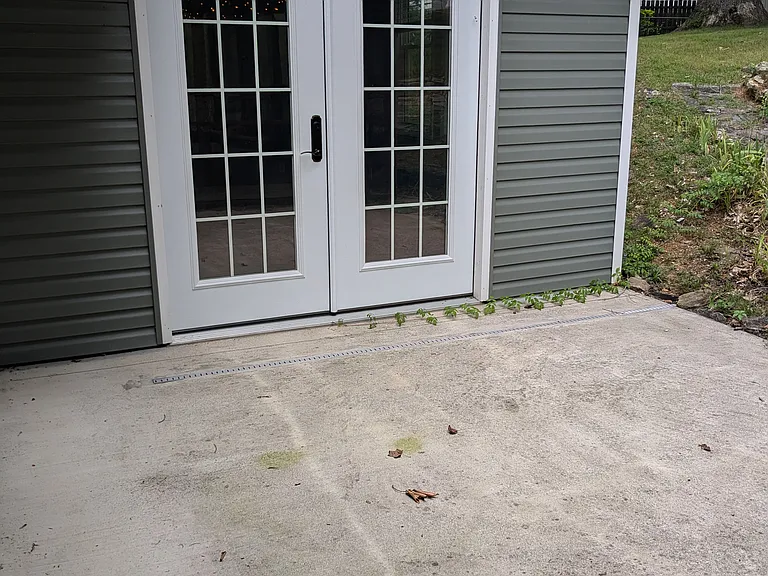 Back patio pad and double doors that access master bedroom