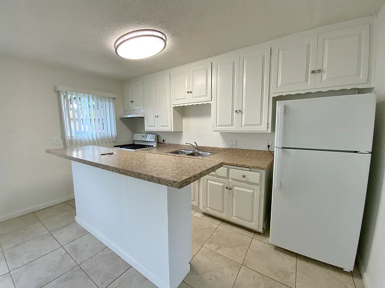 Kitchen; Photos of a similar unit. Available unit has luxury vinyl "wood" plank flooring throughout except in the bedroom (high grade Berber carpet).