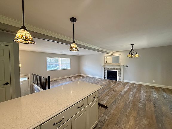 FROM KITCHEN ISLAND REFLECTING THE TIFFANY LIGHTING OVER ISLAND AND DINING AREA