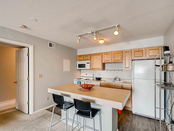 Kitchen island provides a place to gather and eat, along with extra counter space and storage.