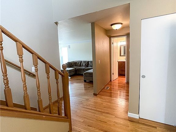 View of hallway that leads to family room, powder room and the laundry is also off the hallway
