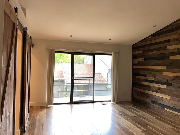 Master bedroom with vaulted ceiling and sliding door to private deck. Plenty of dim-able LED lighting for just the right mood.