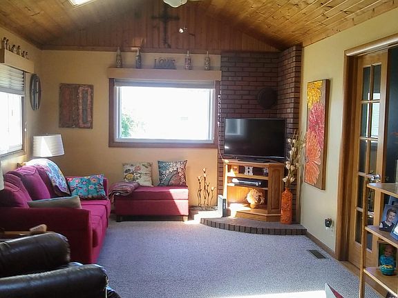 Family room 20Ft by 11 1/2 Ft with tongue and groove wooden cathedral ceiling with sky lights. Berber flooring and French doors.