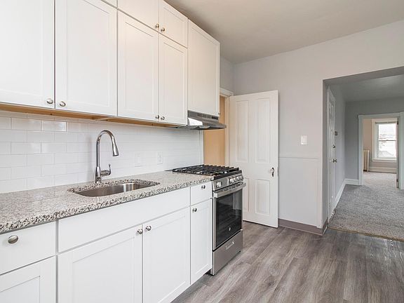 Kitchen - White Shaker Cabinets and Laminate Vinyl Plank Flooring