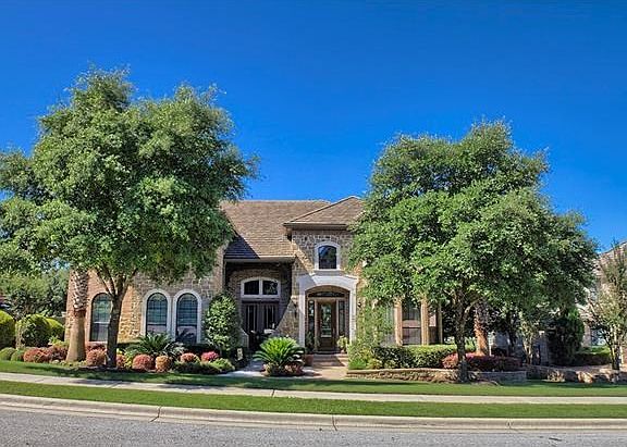 Nice curb appeal with beautiful landscaping and trees