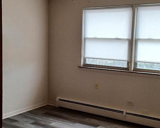 Living area with windows and ceiling fan provided.